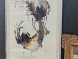 une photo d'un tableau accroché au mur, à côté d'une photo d'un oiseau