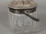 a glass jar with a spoon in it on a table