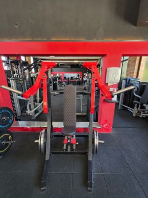 a gym room with a bench, weights, and other equipment