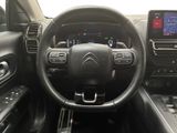 the interior of a car with a steering wheel and dashboard controls