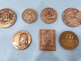 six different types of bronze coins on a blue surface