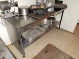 a metal table with pots and pans on top of it