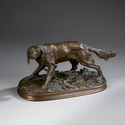 statue of a dog running on a wooden base on a white surface