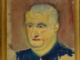 portrait d'un homme vêtu d'une chemise à col bleu, dans un cadre doré