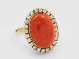 an oval coral and diamond ring