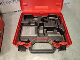 a red tool box with tools in it on a table