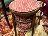 several chairs and a table in a room with a rug on the floor