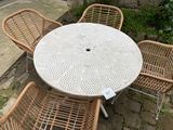 a table and four chairs that are outside on the patio