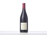 the bottle of red wine is sitting on the table