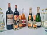 many bottles of wine that are lined up on the table