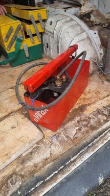 a red box with a cat in it sitting on the floor