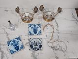 a marble table with blue and white plates and candles on it