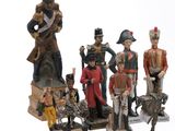 seven figurines of different sizes and colors on display