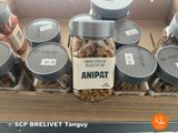 many jars of nuts in a box on display