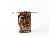 a vase that has a painting on it with a flower in it