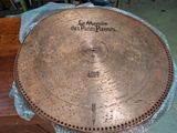 a large metal plate on a table that has writing on it
