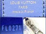 a close up of a blue louis vuitton bag with a zipper