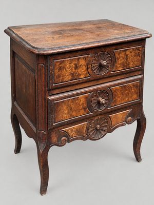 an old wooden chest of drawers with carvings on the drawers