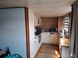 a view of a kitchen with a microwave, oven, and sink
