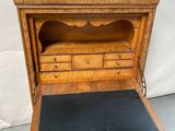 an old wooden desk with a black leather pad on top