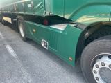 a large green semi truck parked in a parking lot
