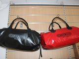 two bags hanging on the wall next to each other