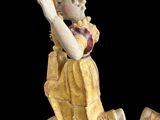 pair of antique figurines of a boy holding a baseball bat