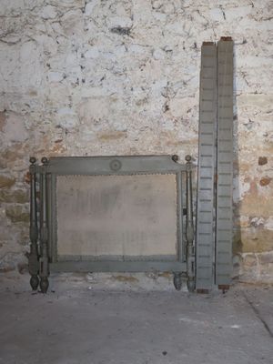 a fire place in the corner of a room with a brick wall