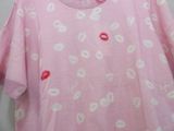 a pink shirt with white and red lips on it