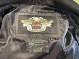 the back of a black leather jacket with a harley logo on it