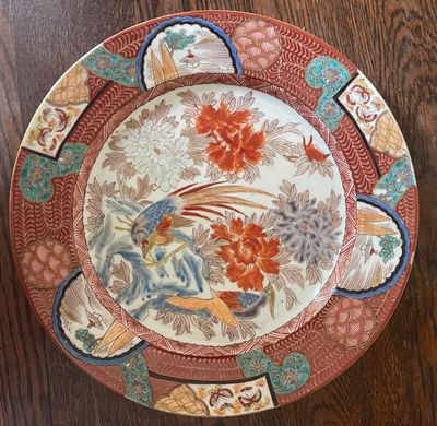 a plate that has a bird on it on a table