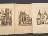 two old books with drawings of buildings on them on a table
