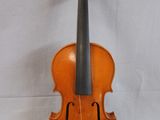 an old violin sitting on a white surface with a white background