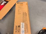 a box and a bag sitting on the floor next to a laptop