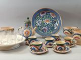 many pieces of pottery sitting on the table together