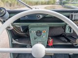 a steering wheel and dashboard of an old green car