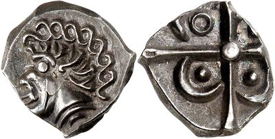 a close up of two silver coins on a white surface