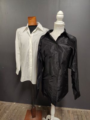 two mannequins in front of a black and white shirt and a white shirt