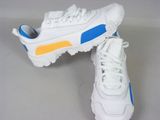 white and blue sneakers with yellow accents on the soles