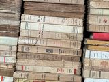 several stacks of old books are stacked on top of each other