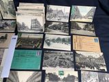 several old postcards of different types and sizes are on a table