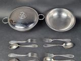a lot of silver spoons and spoons on the table