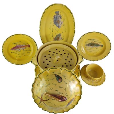 a lot of yellow dishes and bowls with fish on them