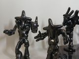 three figurines that are standing next to each other
