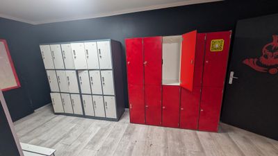 several lockers are lined up in a room with red doors