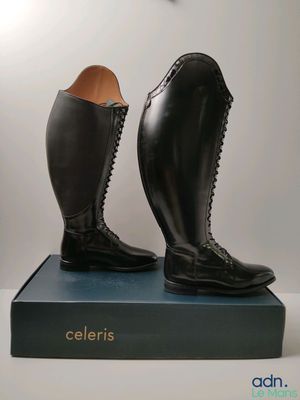 a pair of black boots sitting on top of a blue box