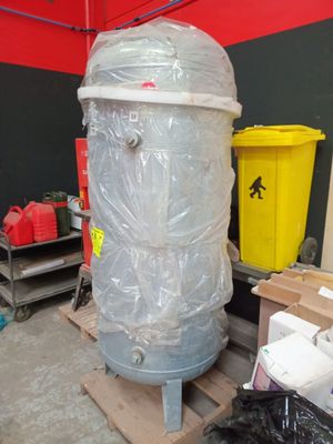 a large metal tank sitting on a pallet in a warehouse