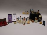 many different types of perfumes on a white surface