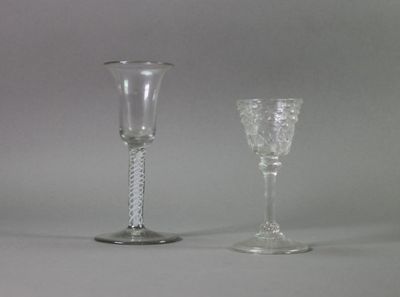 two wine glasses sitting next to each other on a table