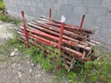 a pile of wood sitting next to a brick wall